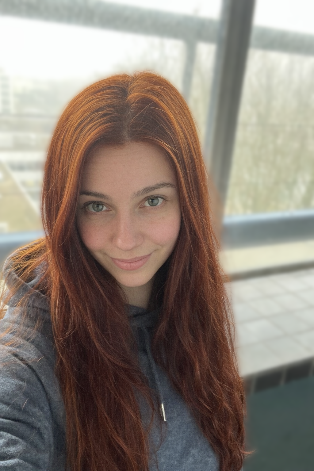 Girl with hair dyed with Hennatura henna based Auburn Red color