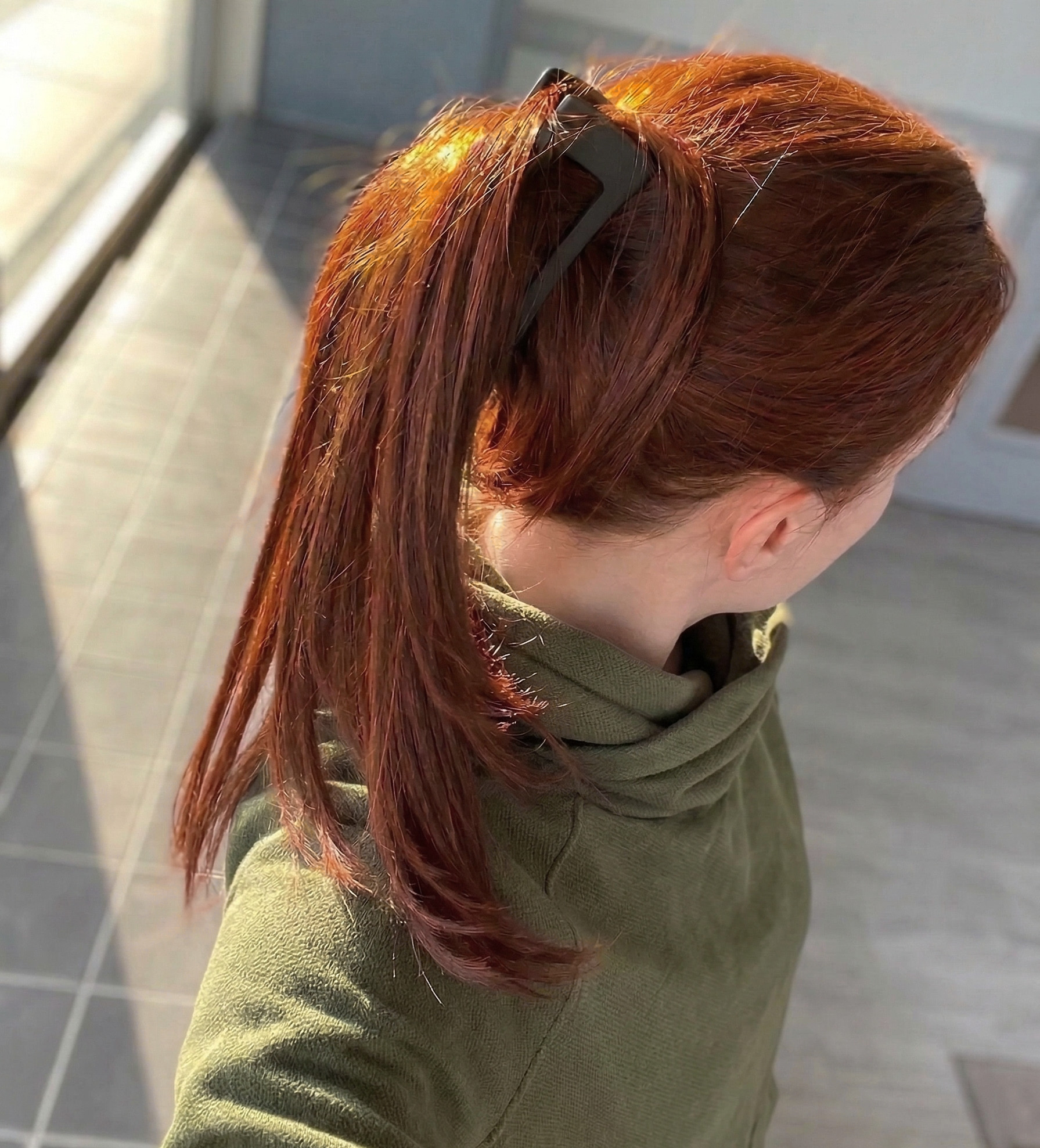 Girl with hair dyed with Hennatura henna based Auburn Red color